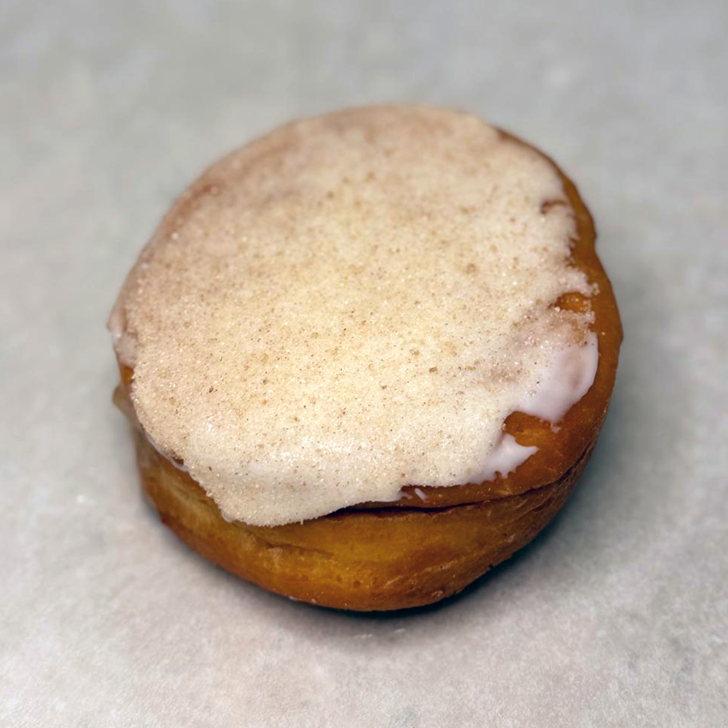 Apple filled donut with cinnamon vanilla icing