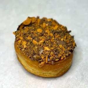 Candy topped ring donut with maple frosting