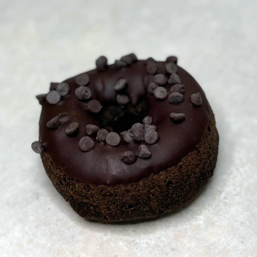 Chocolate cake donut with chocolate icing and chocolate pieces