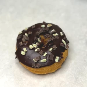 Chocolate glazed donut with mint chocolate pieces