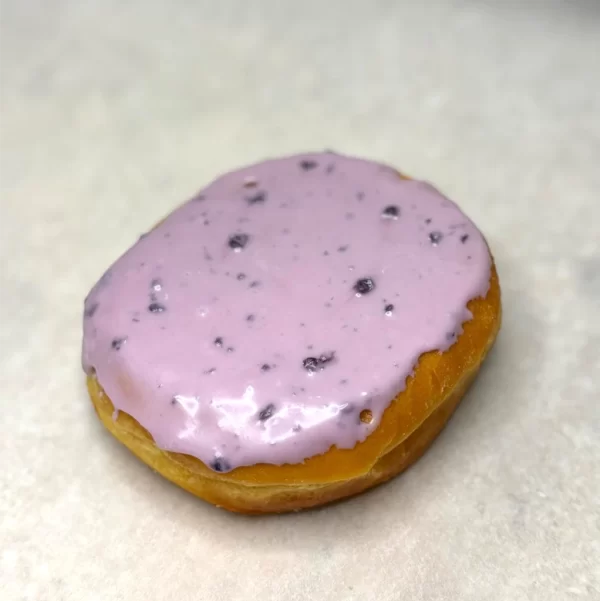 Lemon curd filled donut with blueberry icing