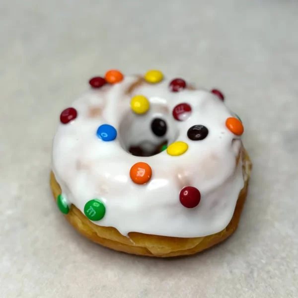 Vanilla glazed donut with M&M