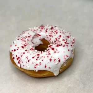 Yeast ring donut with vanilla frosting and assorted toppings